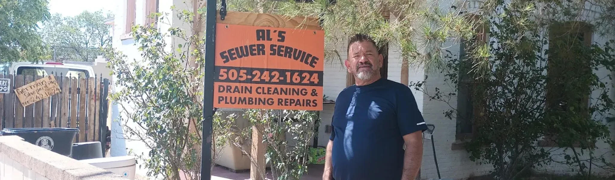 Owner standing by the Al's Sewer Service sign