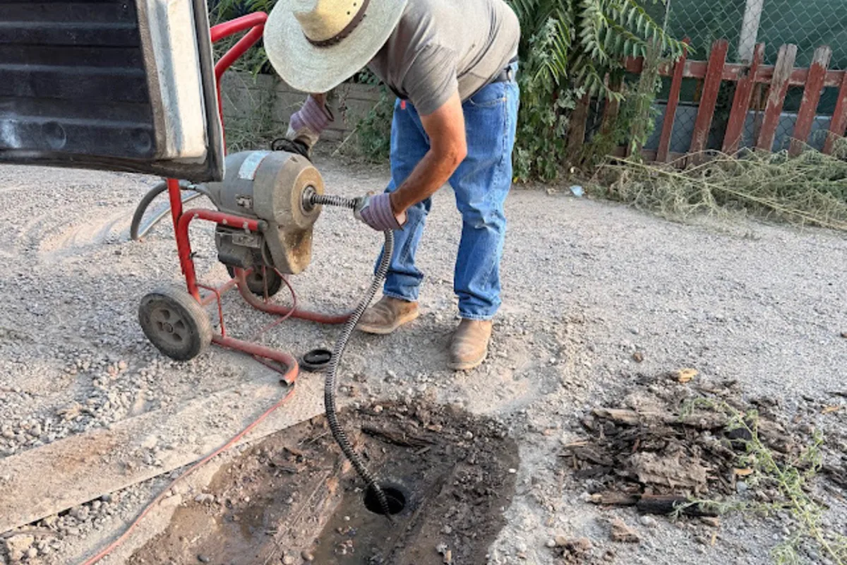 Drain Cleaning In Progress Outdoors Drain cleaning machine clearing an outdoor drain line