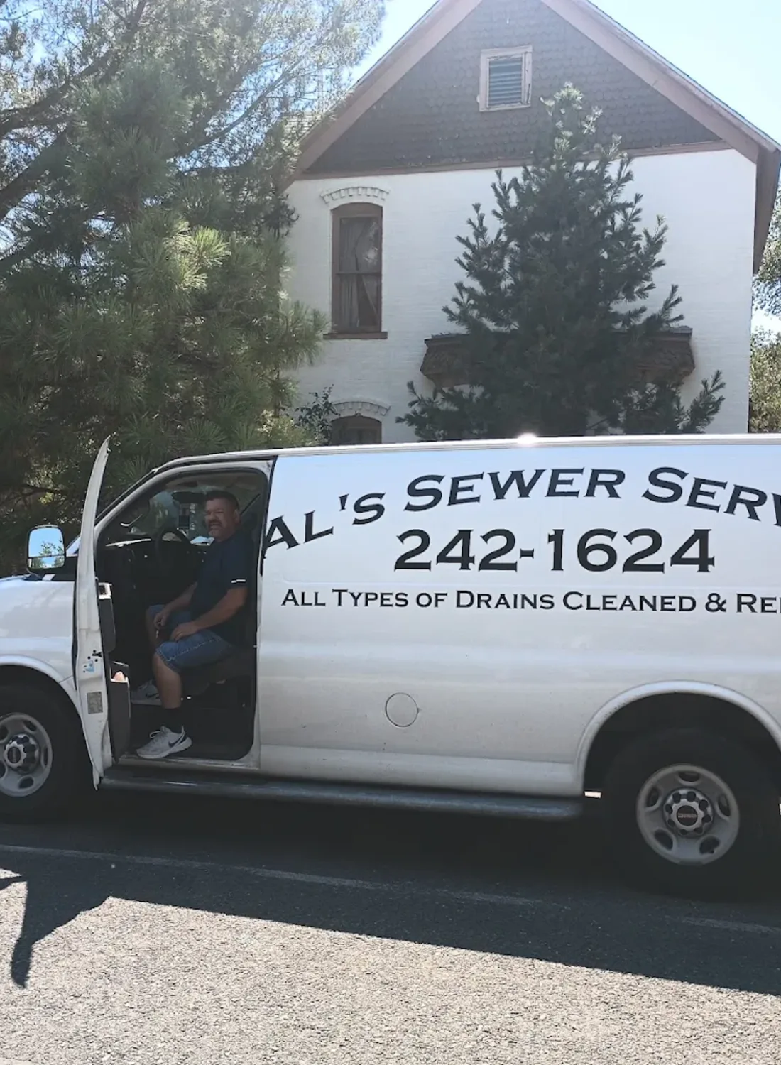 Ready To Help With Your Drain And Sewer Needs Technician seated in the Al's Sewer Service van