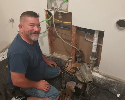 Technician performing drain cleaning service